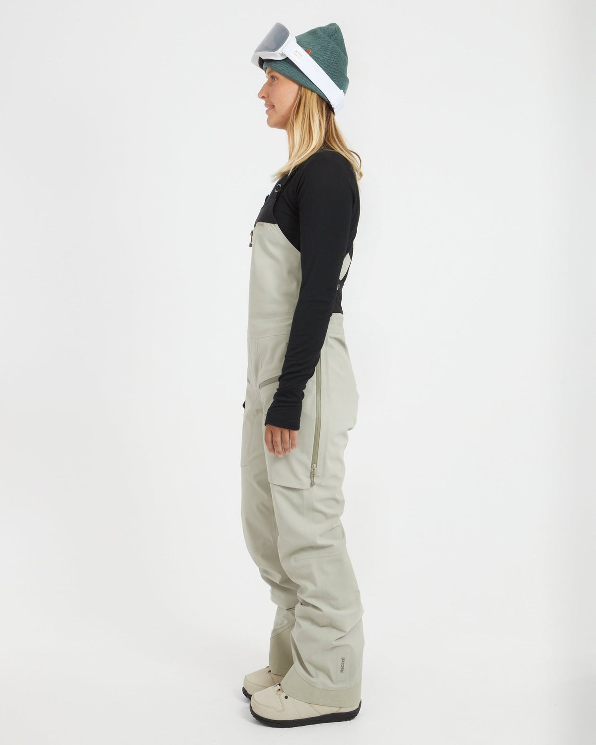Side profile of a woman in the Stone Grey XTM Stellar 2.0 ski bib