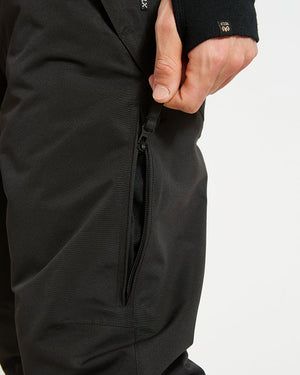 Leg vent zip on the Black XTM Glide ski pant opened to show the mesh guard