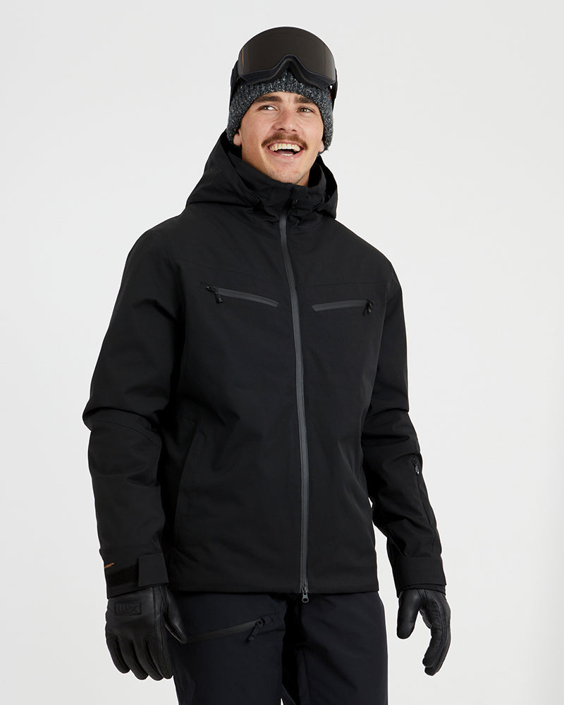 XTM Quantum men's snow jacket in Black, front view on a model wearing goggles and gloves
