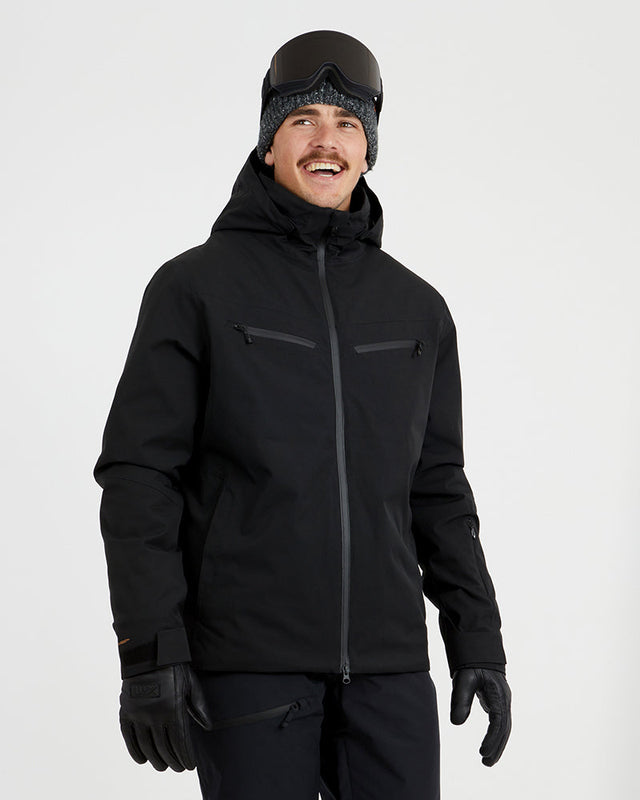XTM Quantum men's snow jacket in Black, front view on a model wearing goggles and gloves