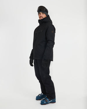 Three-quarter side view of the Black XTM Quantum snow jacket in ski boots