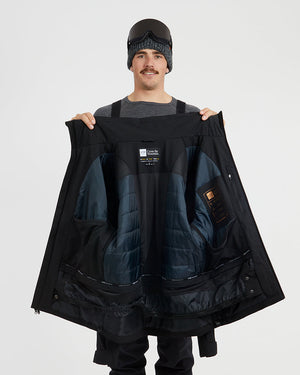 Black XTM Quantum jacket held open to show the quilted insulated lining and powder skirt