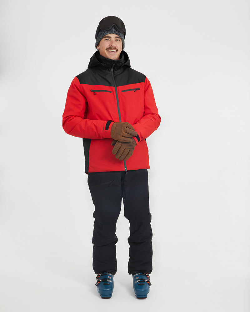 Crimson Red XTM Quantum snow jacket, front view of the model pulling on gloves