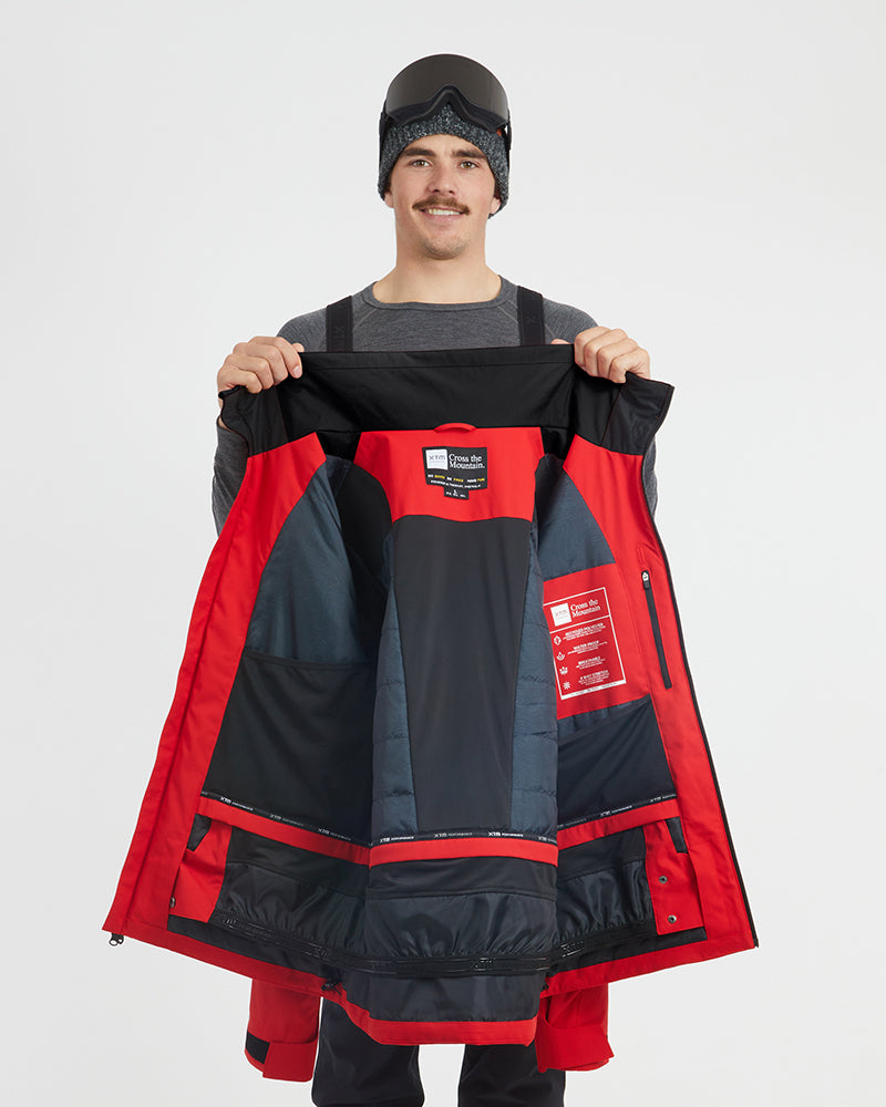 Crimson Red XTM Quantum jacket held open to show the insulated lining and powder skirt