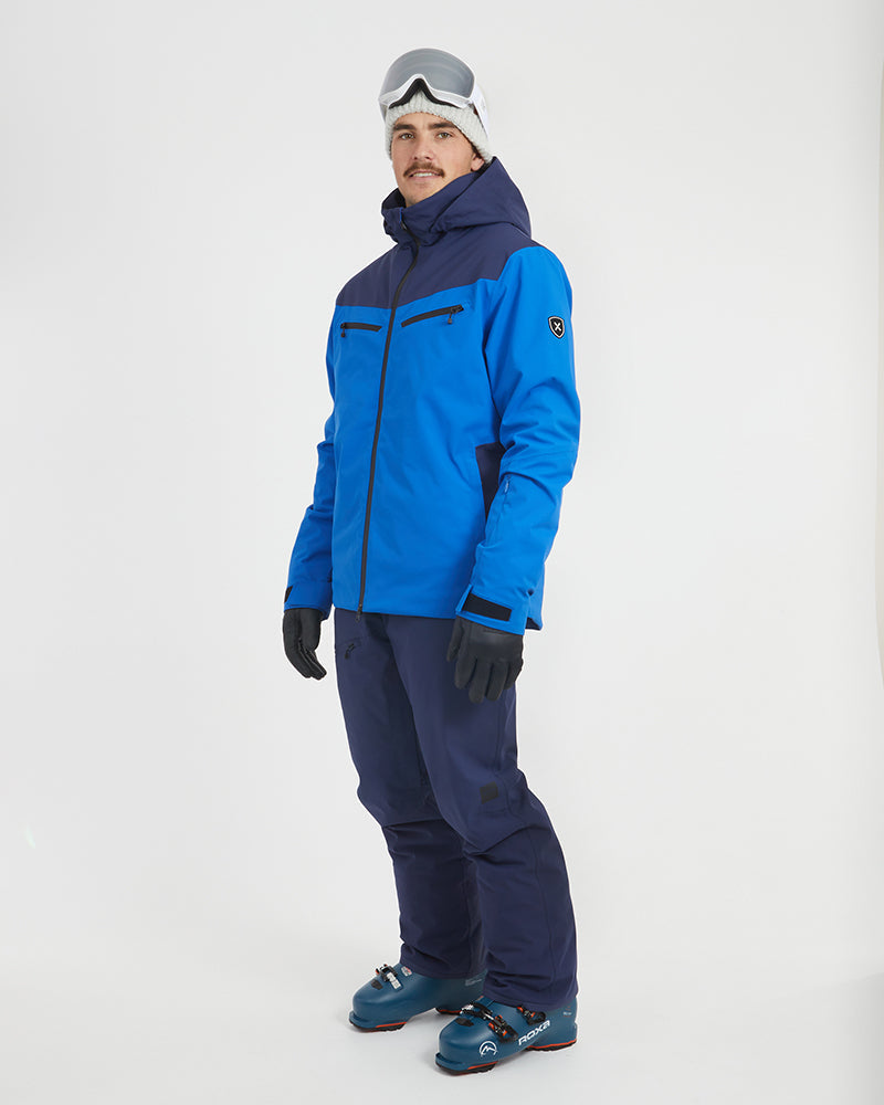 Three-quarter view of the Marine Blue XTM Quantum snow jacket with the sleeve badge visible