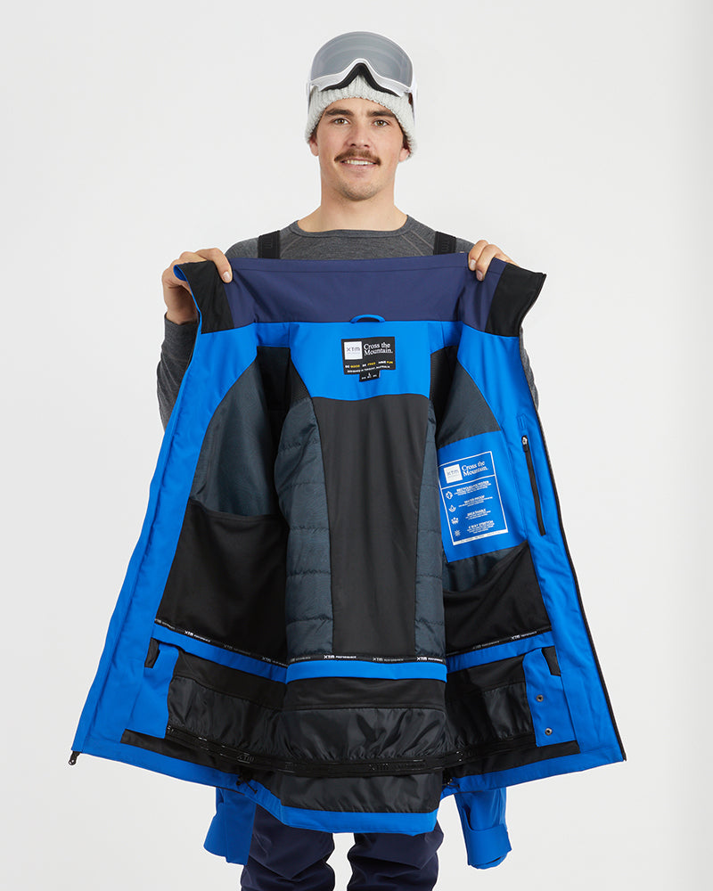 Marine Blue XTM Quantum jacket held open to show the insulated lining, pockets and powder skirt