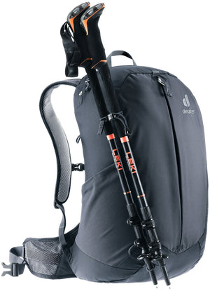 Deuter AC Lite 23 with trekking poles stowed on the pole attachment, front three-quarter view