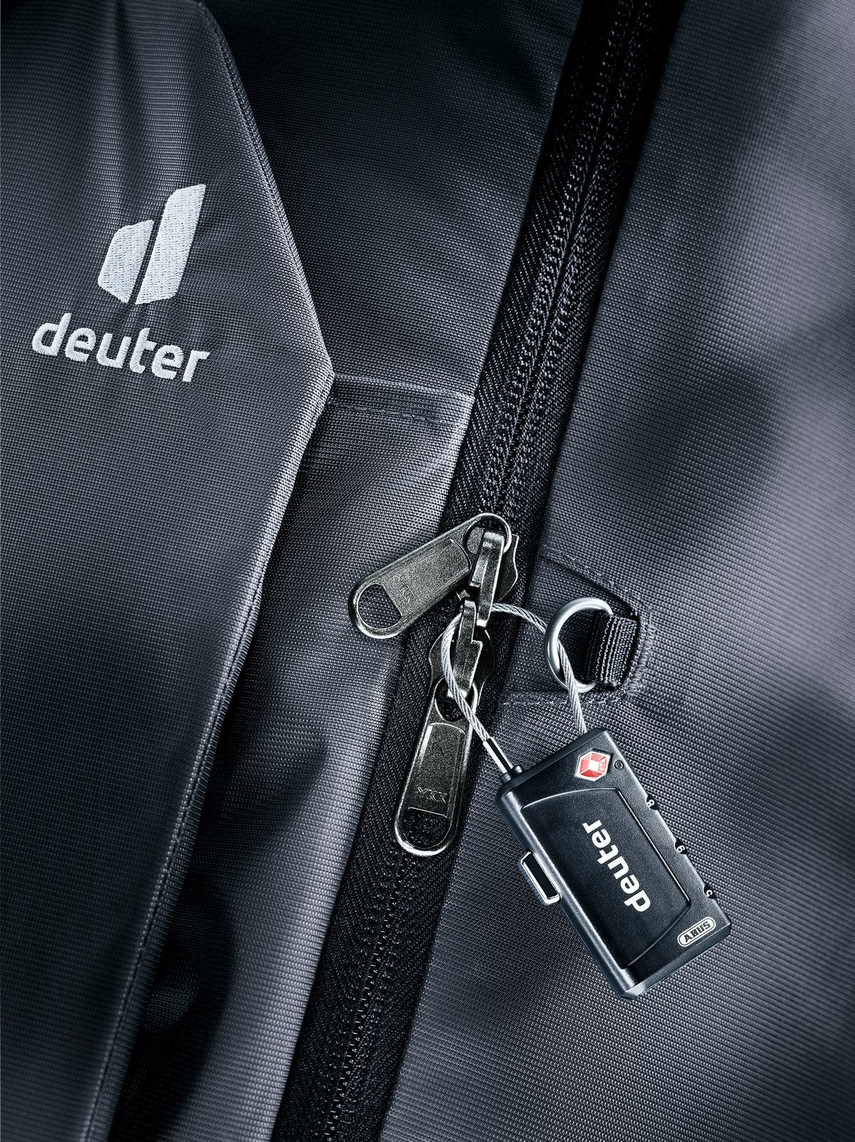 Close-up of a combination padlock on the Deuter Access Pro 65 main zip in Black