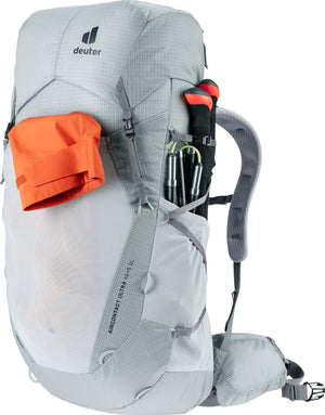 Deuter Aircontact Ultra 45+5 SL with an orange stuff sack in the front pocket and poles at the side