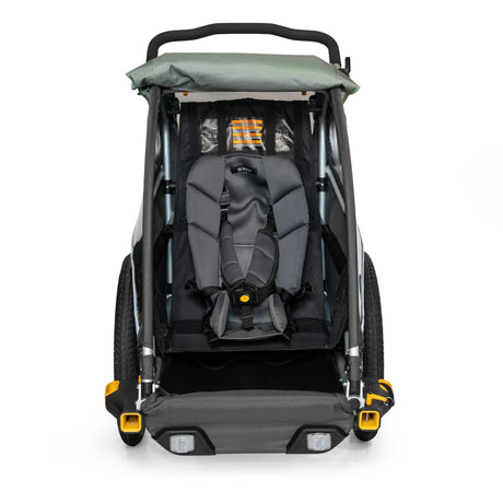 Burley Baby Snuggler fitted in a Burley trailer seat, front view with the harness buckled over it
