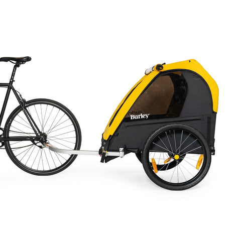 Burley Bee Double trailer hitched to the rear of a bicycle, side view