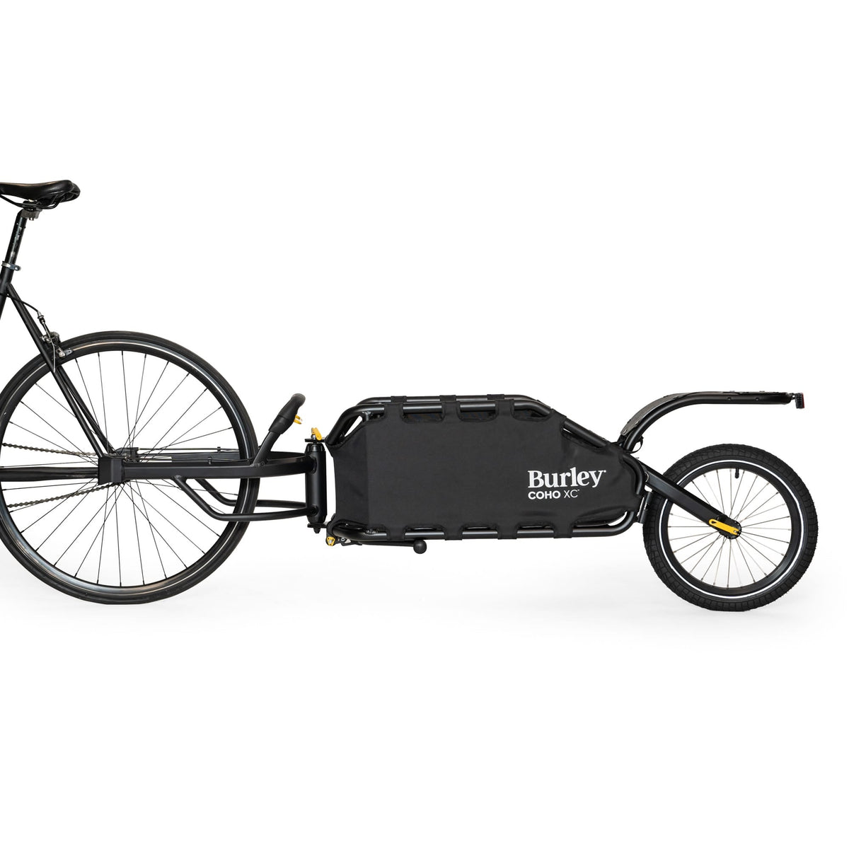 Burley Coho XC hitched behind a black bike, side view showing the single rear wheel and cargo frame