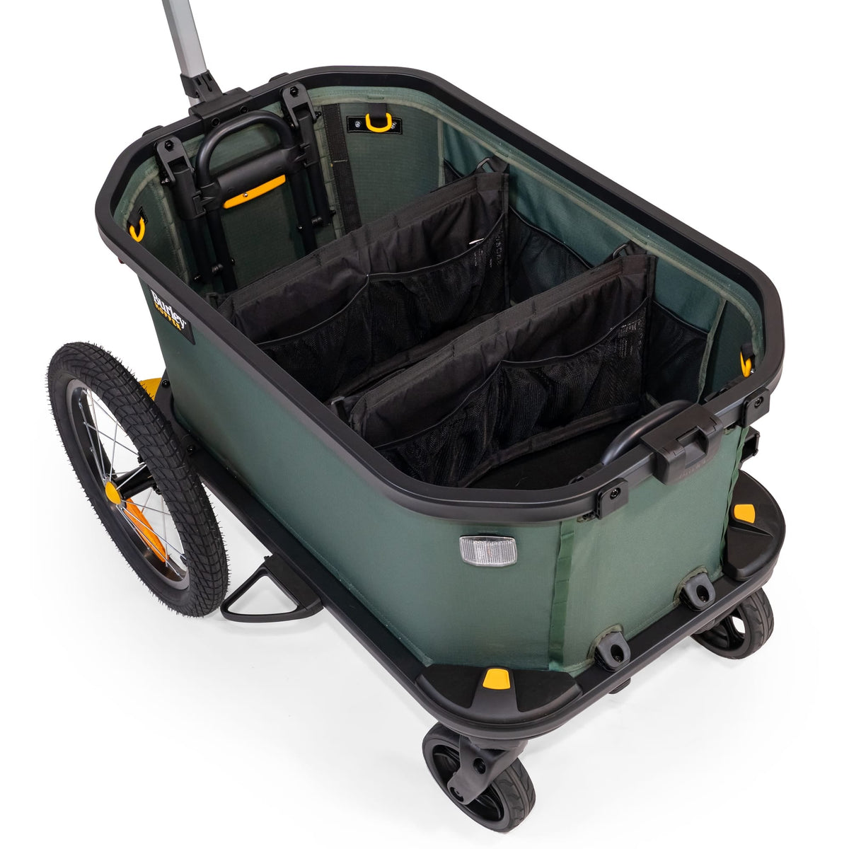 Close view of a green Burley Hopper with two organiser dividers strapped across the empty cargo area