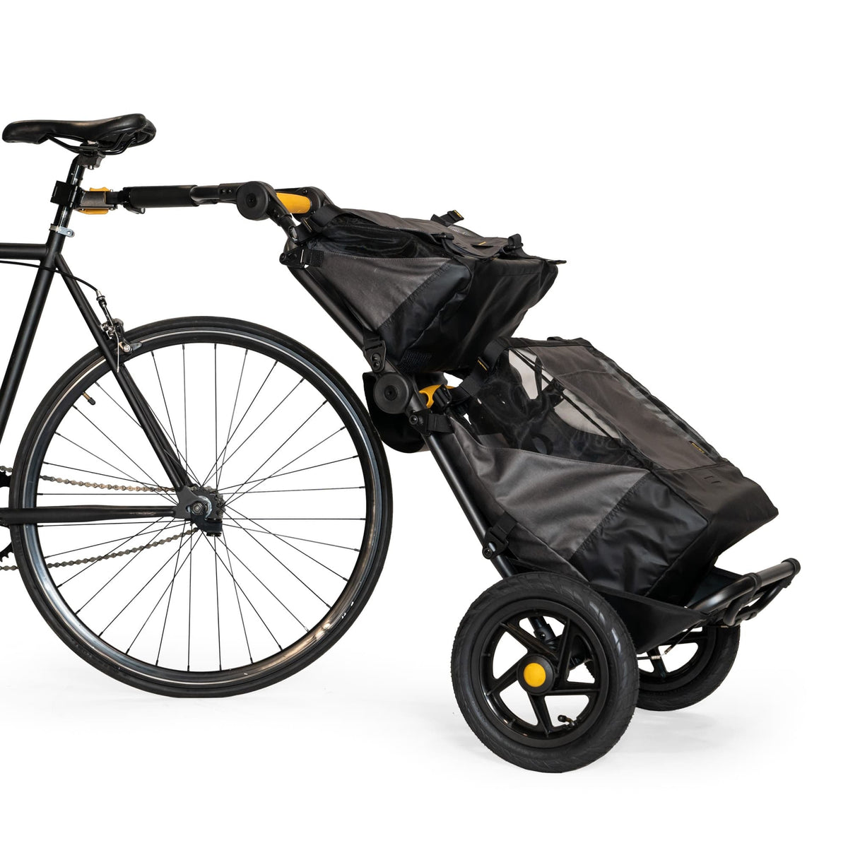 Burley Travoy trailer hitched to a bike with the Upper Market Bag clipped on top and a second bag below