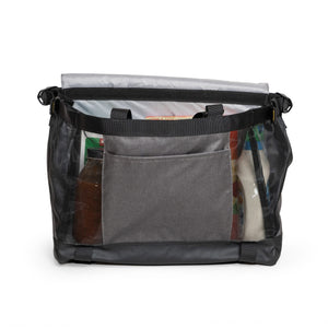 Burley Upper Market Bag with flap open, loaded with groceries behind the front slip pocket and mesh sides