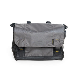 Burley Upper Market Bag in grey with black base and mesh sides, front flap closed with two buckles