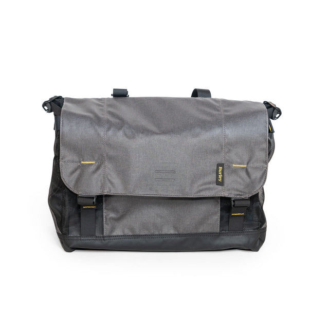 Burley Upper Market Bag in grey with black base and mesh sides, front flap closed with two buckles