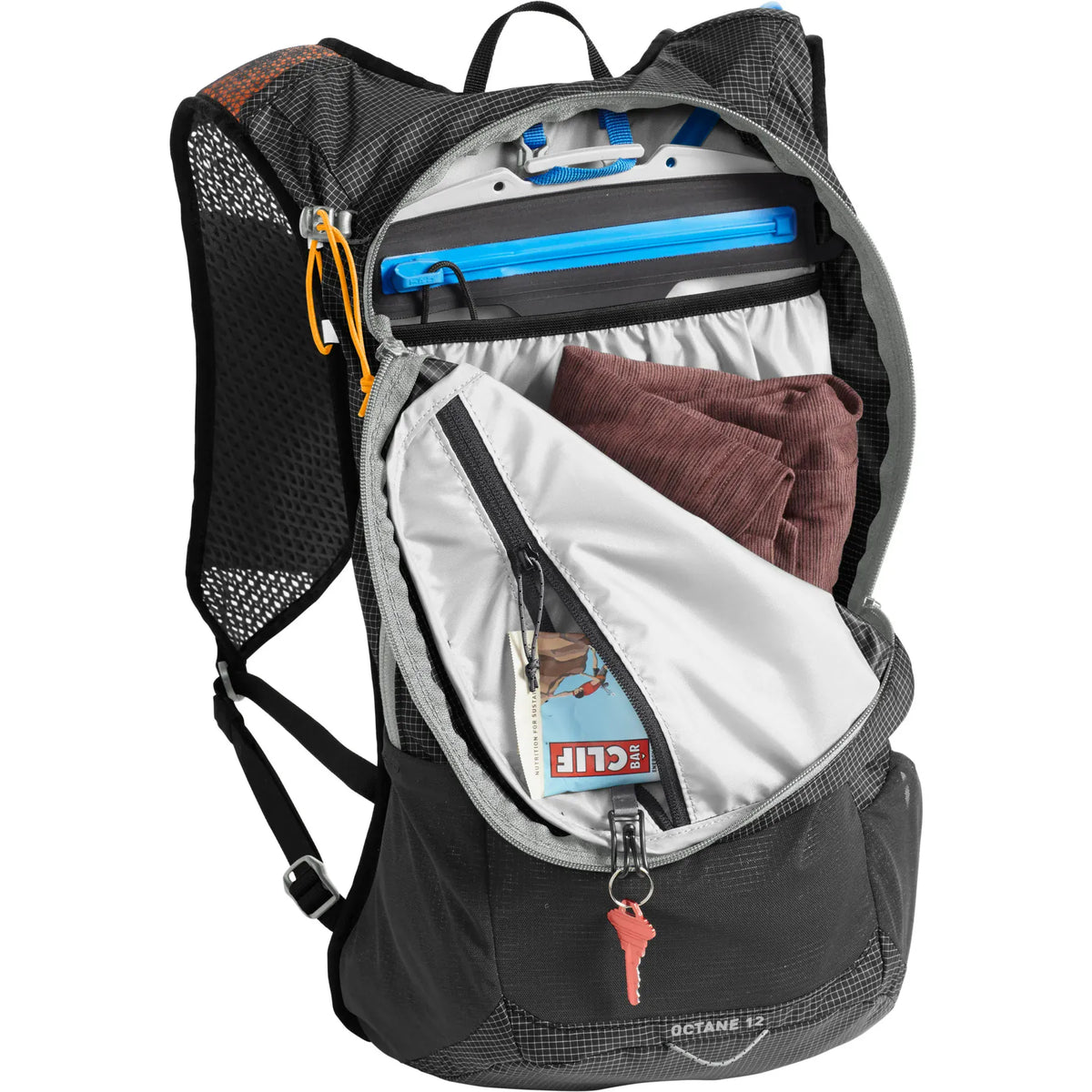 Main compartment of the Octane 12 open, showing the Fusion reservoir, clothing and keys