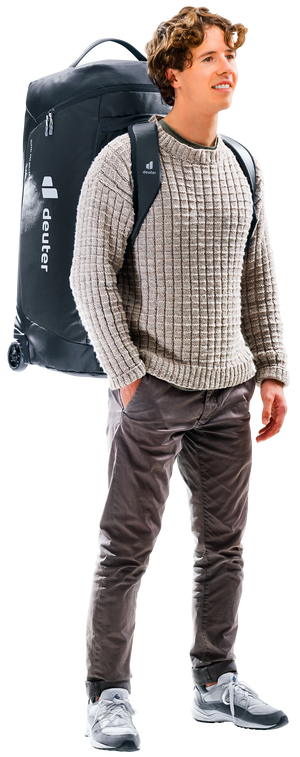 Man carrying the Deuter Duffel Pro Roller 90 as a backpack on its shoulder straps