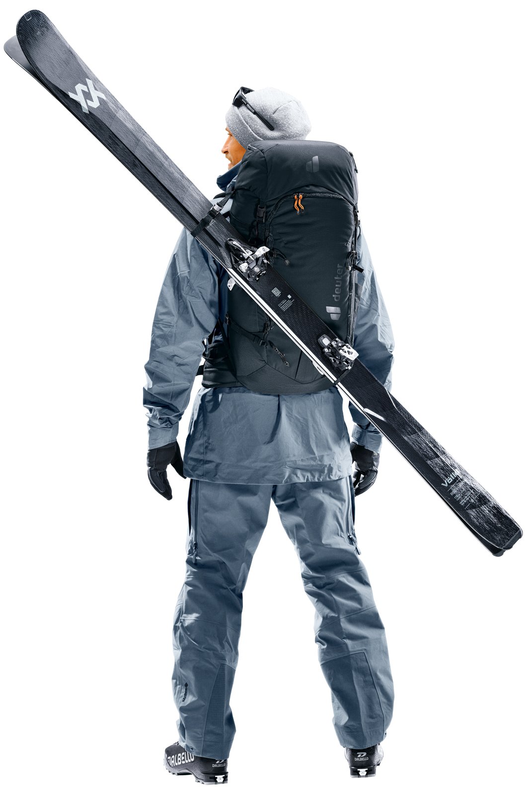 Skier walking with the Deuter Freescape Tour 32, skis carried diagonally across the pack