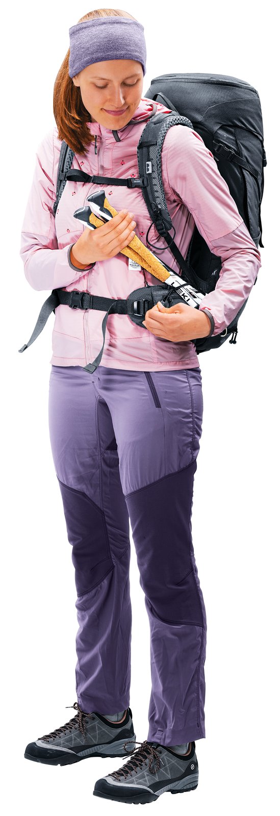 Woman wearing the Deuter Futura Pro 30 SL, stowing a pole in the shoulder strap attachment