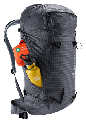 Deuter Guide Lite 30 with a first aid kit and a yellow bottle in an open side pocket