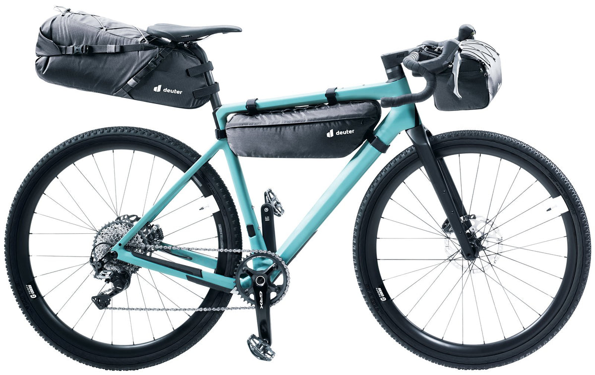 Teal gravel bike carrying the Deuter Mondego SB 16 with Mondego frame and handlebar bags, sold separately