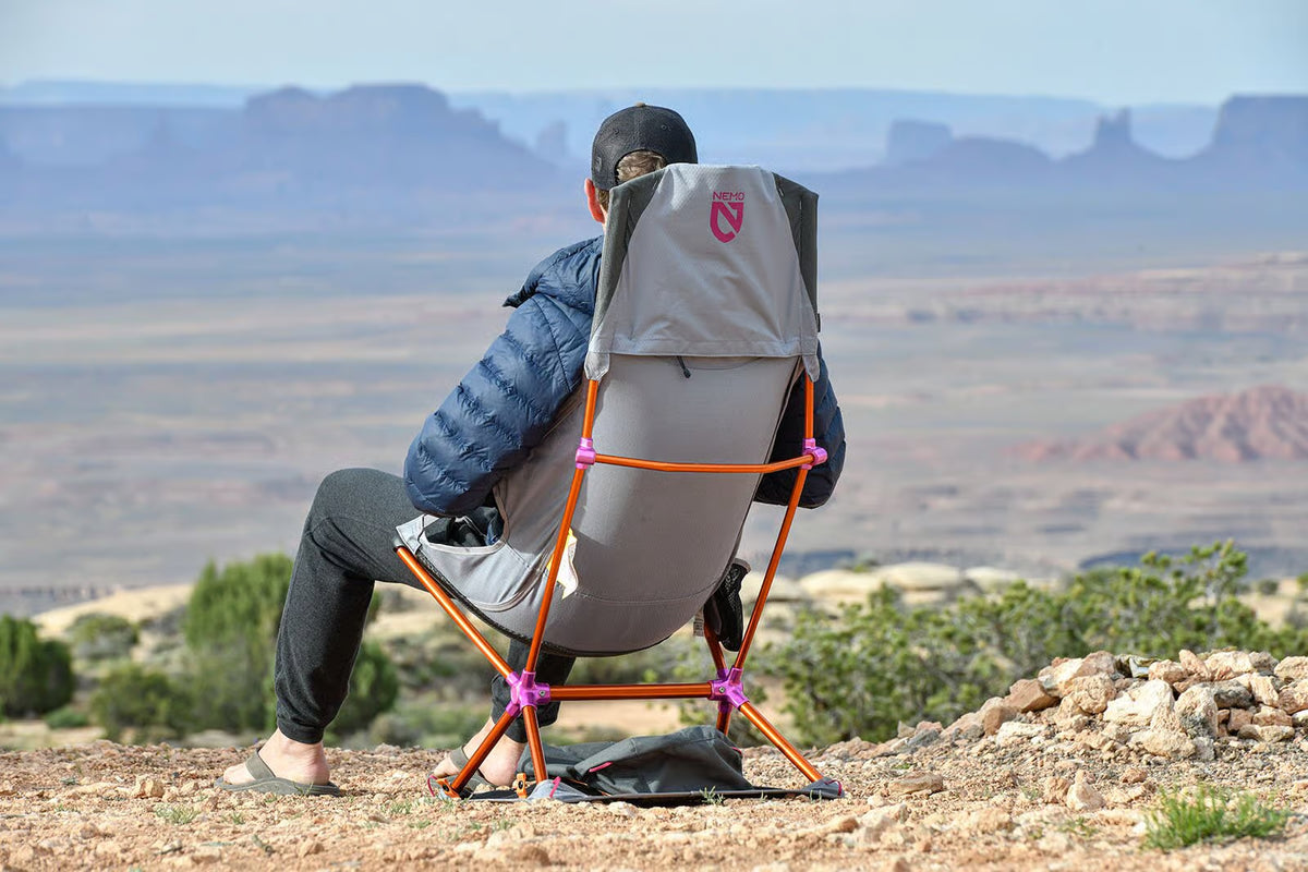 Person in a Nemo Satellite chair on its case looking out over desert mesas