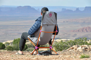 Person in a Nemo Satellite chair on its case looking out over desert mesas