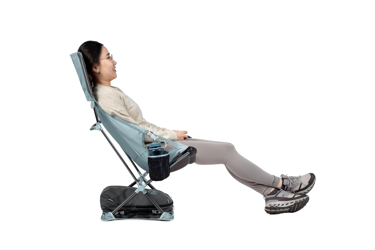 Woman reclining in a Nemo Satellite chair with her legs stretched out