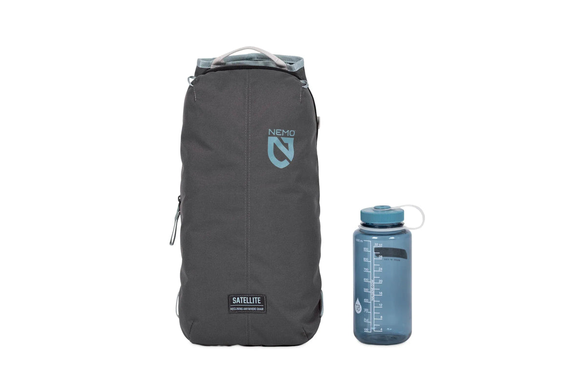 Nemo Satellite Platform Pack Sling carry case packed beside a drink bottle for scale