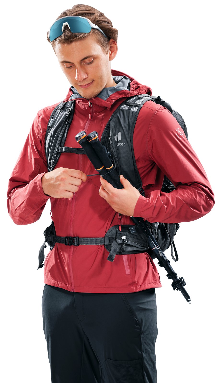 Deuter Speed Lite Pro 25 worn by a hiker securing folded poles in the shoulder strap pole holder