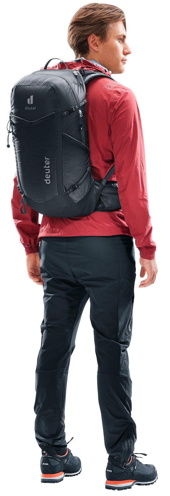 Hiker in a red jacket wearing the Deuter Speed Lite Pro 25, seen from behind