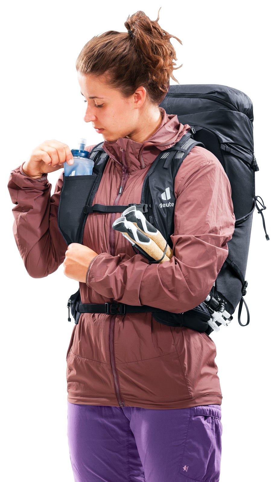 Deuter Speed Lite Pro 28 SL worn by a woman taking a soft flask from the shoulder strap pocket