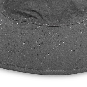 Close-up of water droplets beading on the grey storm hat fabric and brim seam