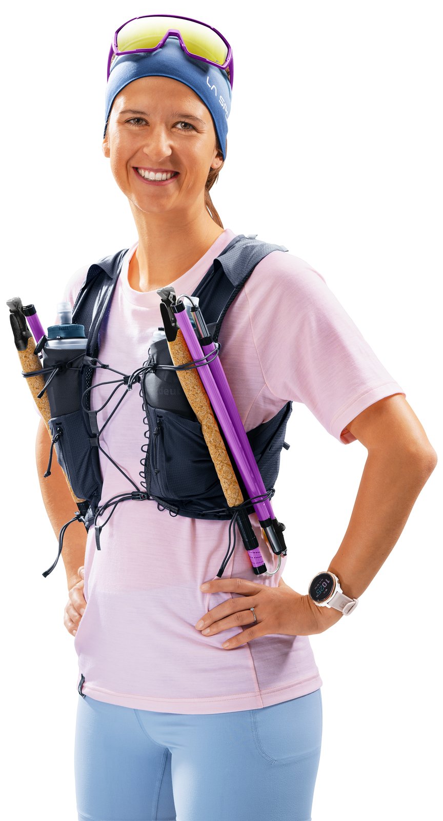 Woman wearing the Deuter Traick 5 SL with folded poles carried on the front