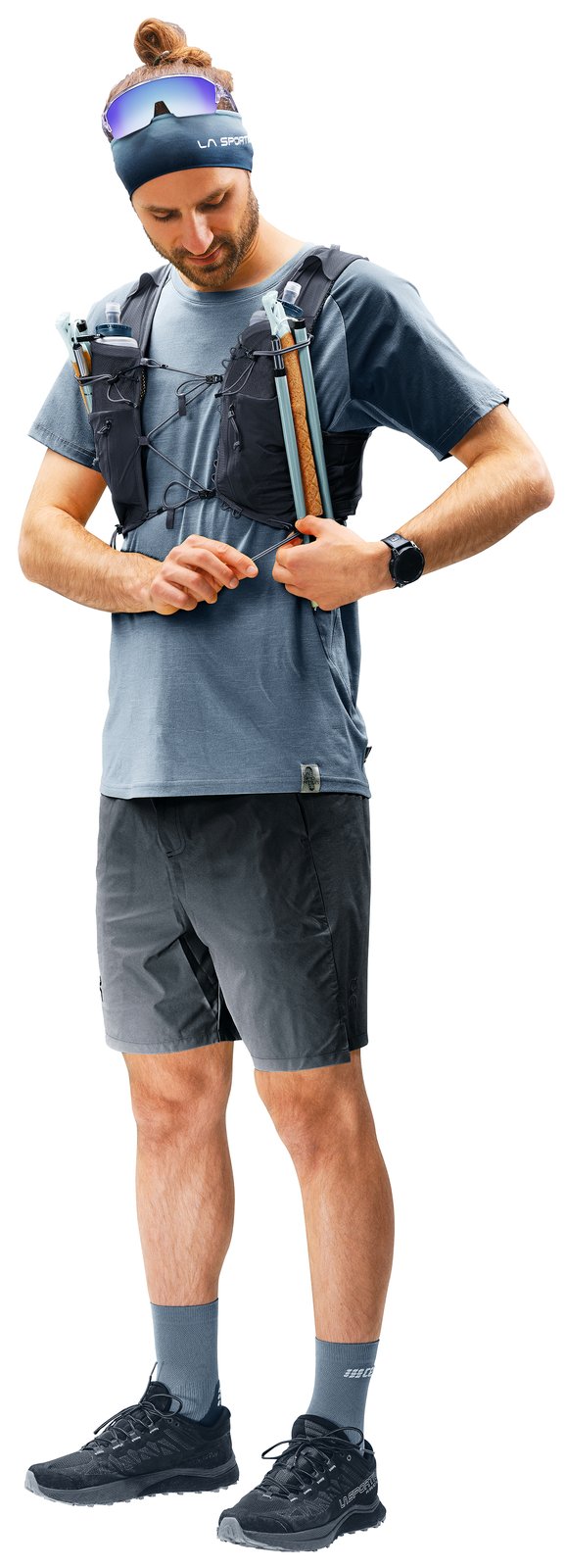 Trail runner wearing the Deuter Traick 9 and adjusting the bungee sternum strap