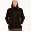 Woman wearing the black XTM Marley women's fleece jacket zipped up, with a chest pocket and woven badge